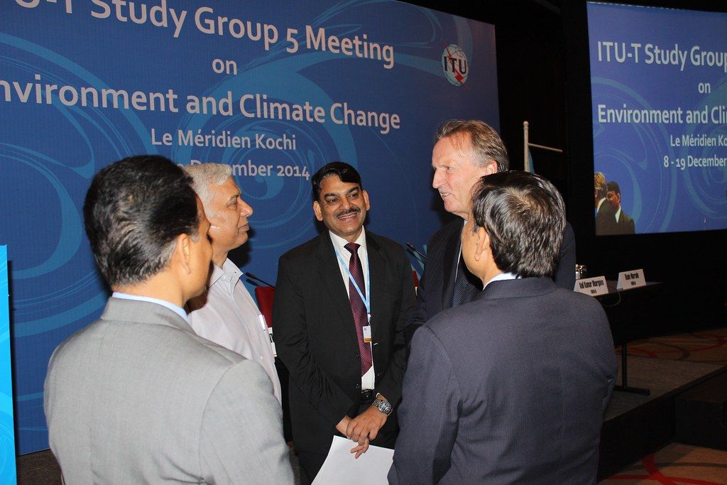 Delegates talking in small groups during a break at a conference