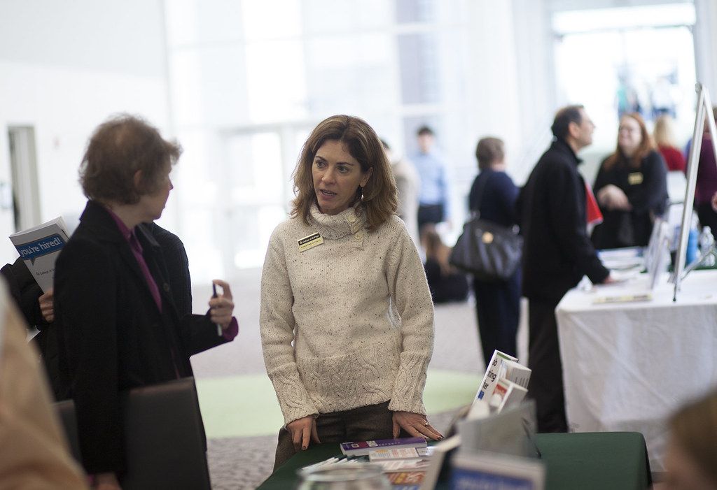 Two people talking at an exhibition stand